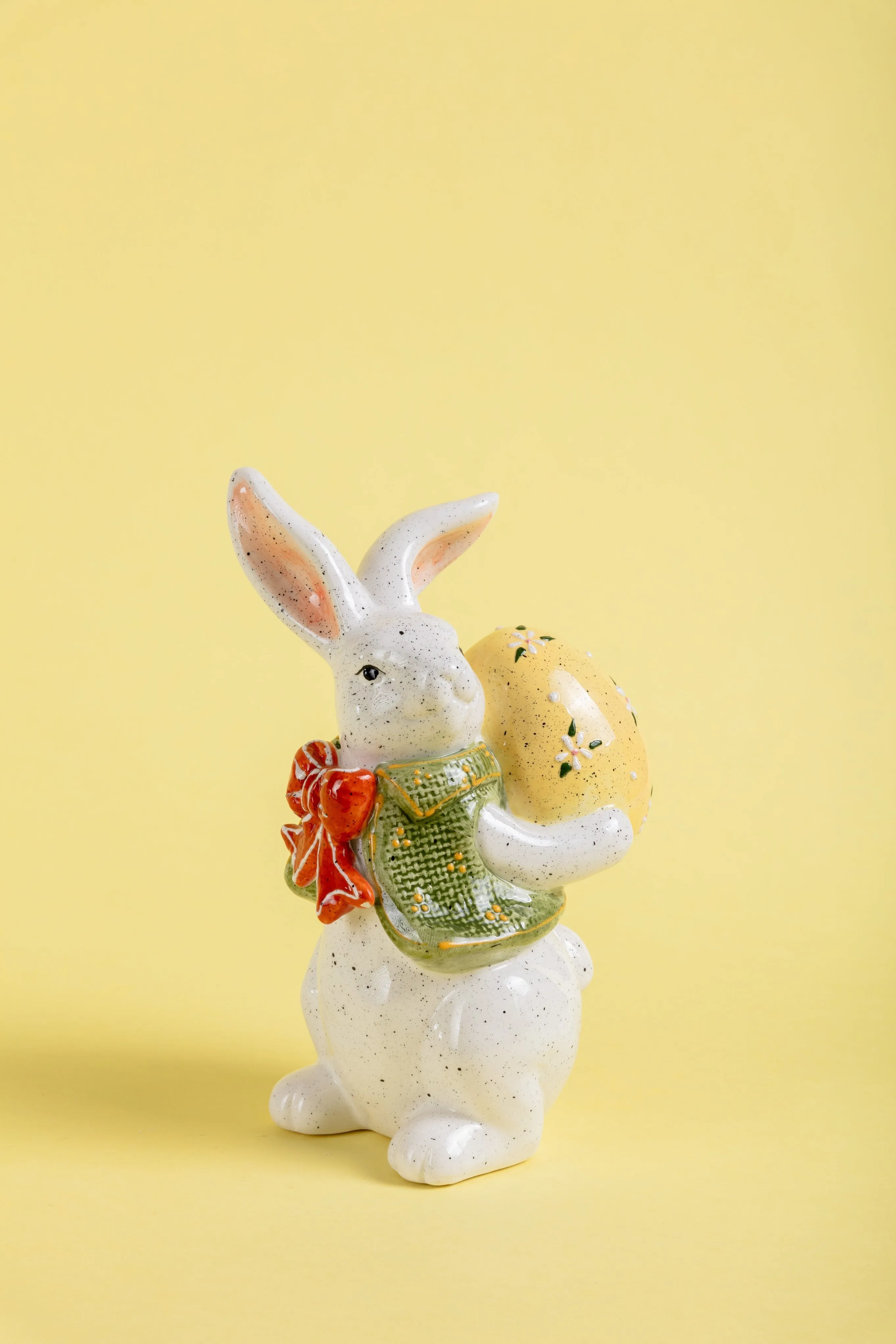 Ceramic Bunny with Red Bow Holding an Easter Egg